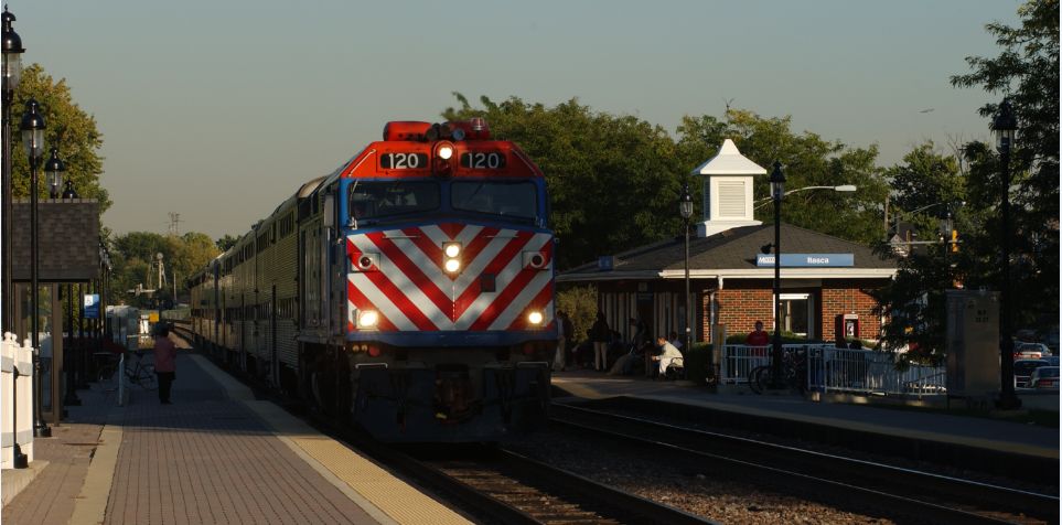 A train approaching a metra lot